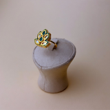 Gold-colored small ring with kundan stones and green details
