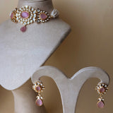 Gold-colored jewelry set with pink stones and pearls