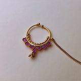 Gold-colored medium-sized nose rings with pink stones