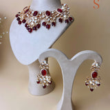 Gold-colored jewelry set with stones and red beads