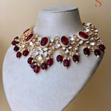 Gold-colored jewelry set with stones and red beads