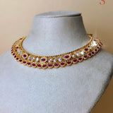 Gold-colored jewelry set with gold-colored and red stones