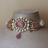 Gold-colored jewelry set with pink stones and pearls