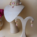 Gold-colored jewelry set with pink stones and pearls