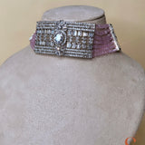 Silver-colored jewelry set with light pink stones
