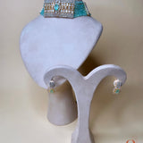 Gold-colored jewelry set with light blue beads