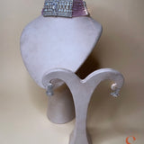 Silver-colored jewelry set with light pink stones