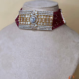 Gold-colored jewelry set with dark red stones