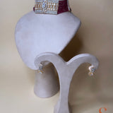 Gold-colored jewelry set with dark red stones